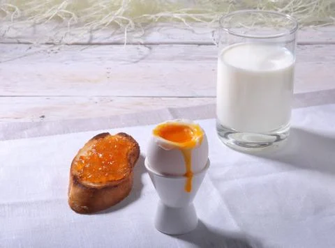 Healthy Morning Breakfast set with egg, orange jam on bread toast and milk in Stock Photos