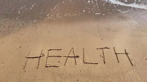 Healthy New Year concept. Text Health handwritten in sand surface and blue .. Video stock 251801547