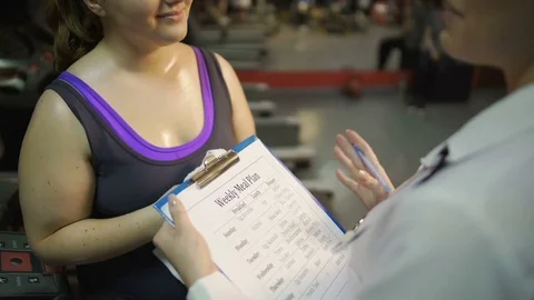 Healthy nutrition expert making weekly meal plan for client, weight loss program Video stock 73468611