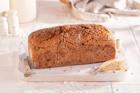 Healthy oat bread baked in a rustic bright kitchen. Stock Photos