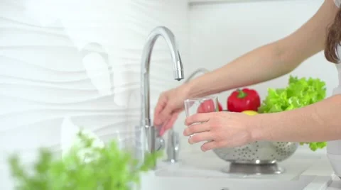 Healthy pregnant woman drinking fresh water in the kitchen Stock Footage 59087685
