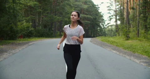Healthy running runner man workout on road. Jogging female fitness model working Stock Footage 202211270