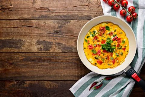 Healthy rustic Breakfast, scrambled eggs with greens and cherry tomatoes with Stock Photos