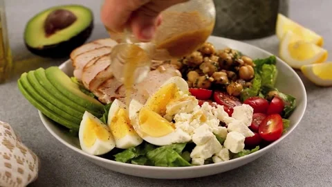 Healthy salad with grilled chicken with dressing pouring over Stock Footage 242525774