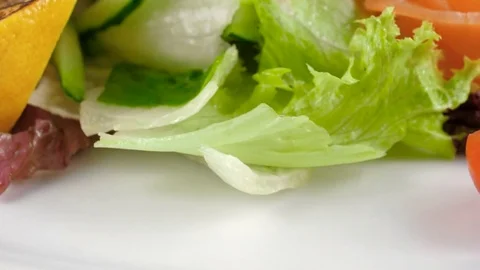 Healthy salad with salmon, close-up view, camera moves from bottom to top Stock Footage 81002733