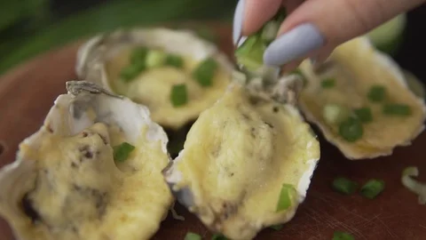 Healthy seafood, closeup serving open oysters with cheese and green onion in a 스톡 동영상 91200993