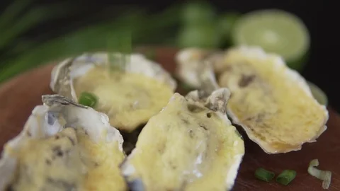 Healthy seafood, closeup serving open oysters with cheese and green onion in a Stock Footage 91201020