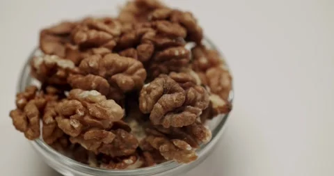 Healthy shelled walnuts rotating on white background Stock Footage 329293134