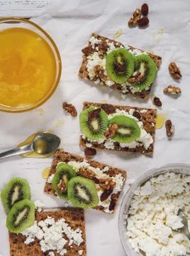 Healthy snack with cheese cottage, kiwi and honey Stock Photos