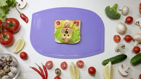 Healthy snack in dog shape on violet cutting board Stock Footage 231224013