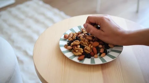 Healthy snack with mixed nuts on a table Stock Footage 341647690