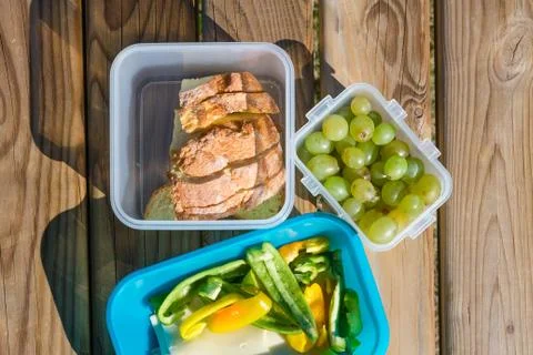 Healthy snack which consists of bread, grape, cheese and paprika in a plastic Stock Photos