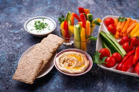 Healthy snacks. Vegetables and hummus Stock Photos