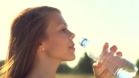 Healthy teen girl drinking water from th, Stock Video
