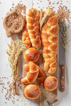 Healthy variety of breads on table in rustic kitchen. Stock Photos
