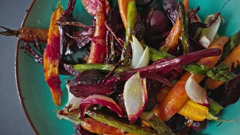 Healthy vegan meal of roasted root vegetables served on a rustic plate. Stock Footage 336968549