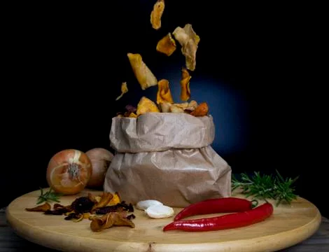 Healthy vegetable chips falling in a paper bag Stock Photos