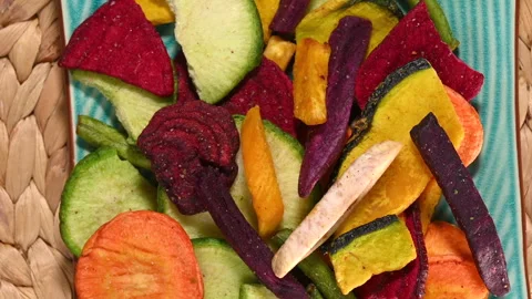 Healthy vegetable chips rotating on a plate Stock Footage 333124859