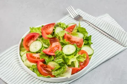 Healthy vegetarian dish on table, vegetable salad with fresh tomato, cucumber Stock Photos
