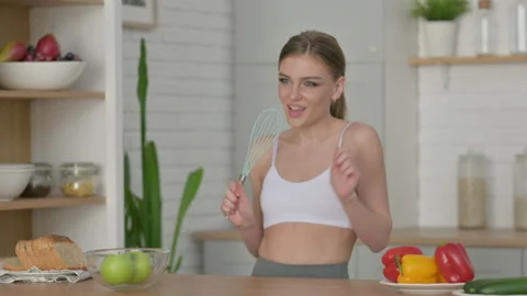Healthy Woman Dancing while Cooking in Kitchen Stock Footage 154714965
