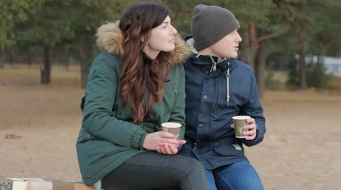 Healthy young couple taking time alone together wearing warm clothing sitting Stock Footage 57352482