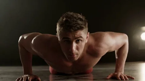 Healthy young man doing push-ups Stock Footage 69235343