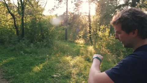 Healthy young man jogging through a park on a sunny morning. with fitness Stock Footage 79793744