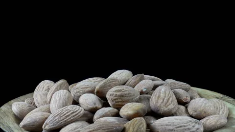 A heap of almonds on plate rotates close-up Video stock 137239731