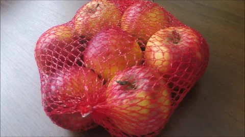 The heap of apples packaged in the red net Stock Footage 45864578