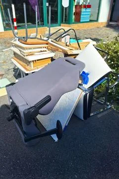 A heap of assorted discarded household items and furniture piled up on a Stock Photos
