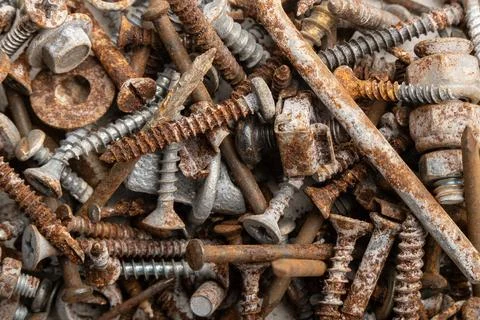 Heap of assorted metal fasteners, combining heavily rusted nails and screws.. 写真素材