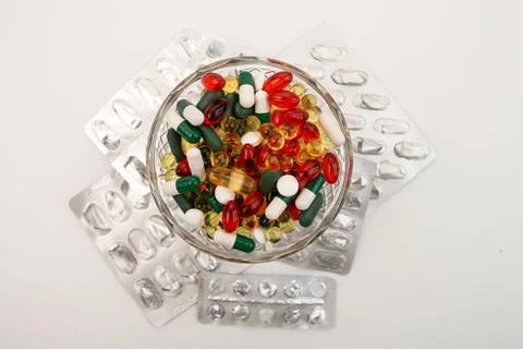 Heap of assorted various medicine tablets and pills in blisters different col Stock Photos
