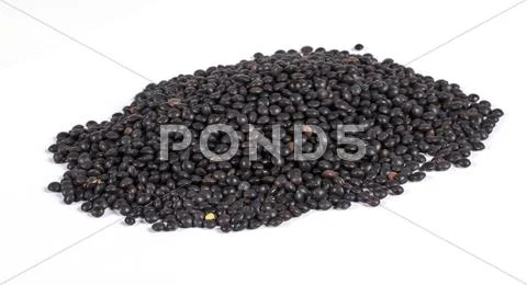 Heap of black lentil isolated on white Stock Photos