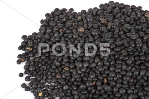 Heap of black lentil isolated on white Stock Photos