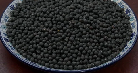 Heap of black soybean on a plate. Table spin. Video stock 279570595