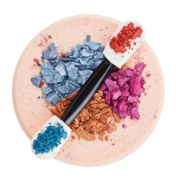 Heap of broken multicolor eyeshadow over makeup sponge, isolated on white mac Fotos Stock