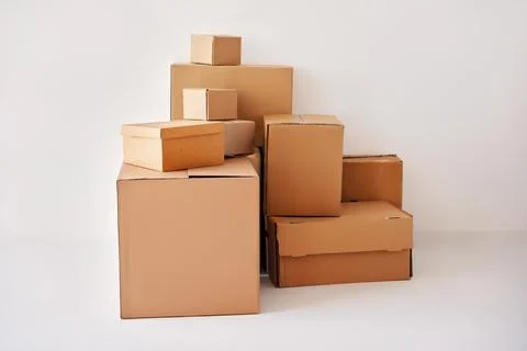 Heap of cardboard boxes on white backround 库存照片
