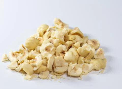 Heap of chopped hazelnut on white background Stock Photos