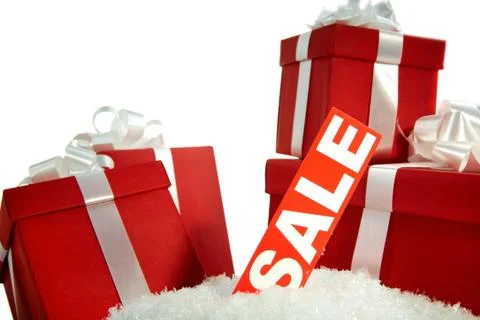 A heap of christmas gifts in snow with sale tag near by Stock Photos