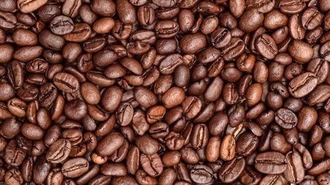 Heap of coffee beans rotating on the table Stock Footage 240540612