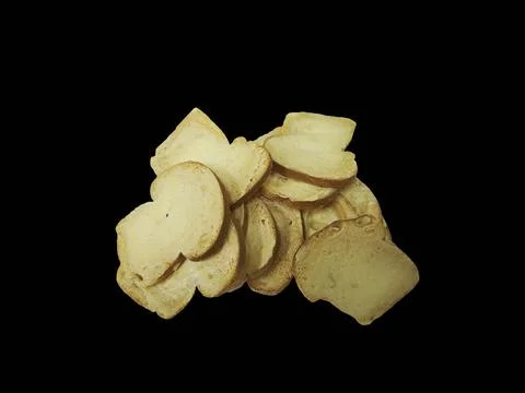 Heap of crispy baked bread chips isolated on black background. Stock Photos
