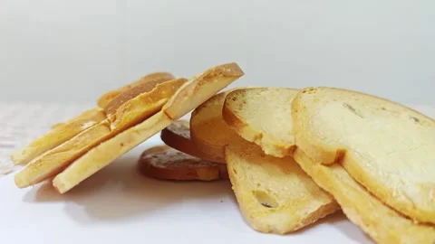 Heap of crispy baked bread rusks leaning on white background. 스톡 동영상 339991089