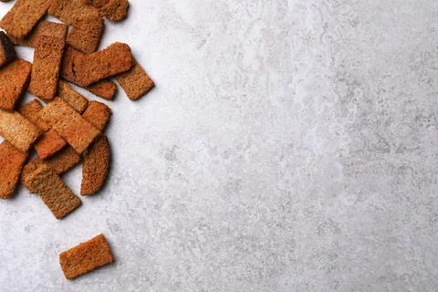 Heap of crispy rusks on light table, flat lay. Space for text Stock Photos