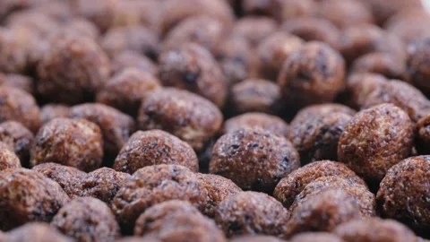 Heap of crunchy breakfast corn flakes, dry chocolate-flavored cereal balls. Stock Footage 296555503