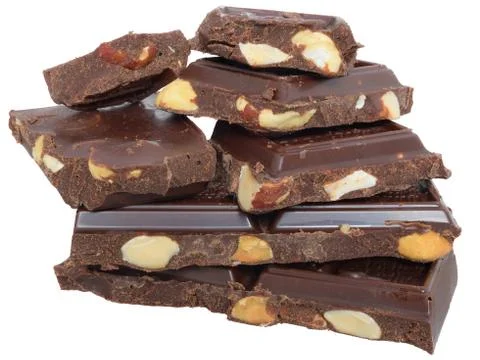 Heap cubes of chocolate with nuts close up isolated Stock Photos