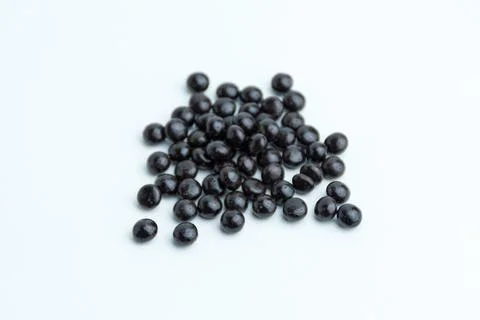 Heap of dark chocolate chips drops isolated on a white background Stock Photos