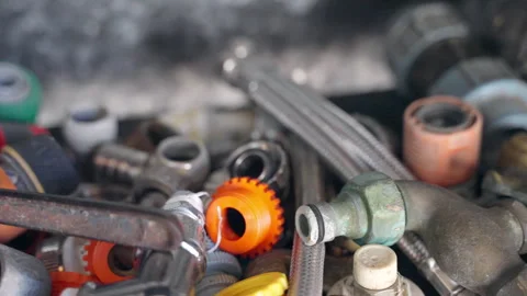 Heap of different industrial tools on shelf in workshop, rusty metal pipes Stock Footage 338249908