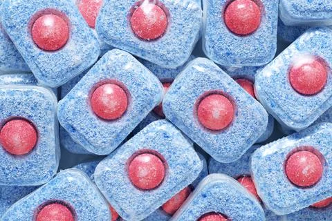 Heap of dishwasher detergent tablets background. Stock Photos