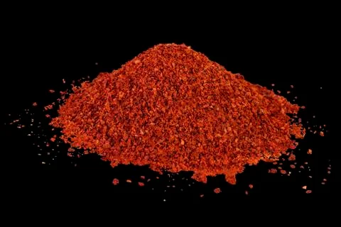 Heap of dried crushed hot red pepper on isolated black Stock Illustration