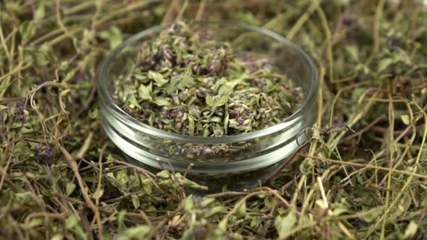 Heap of the dried herb thyme and glass jar with peeled thyme, slow motion Stock Footage 278037955